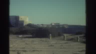 Greece (1976): A Woman Talks To Her Husband Near A Lighthouse On A Windy Day