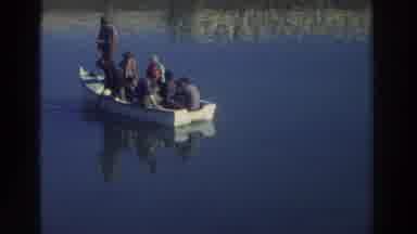 GREECE-1976: Seven Men In A Rowboat Sailing On Calm Waters