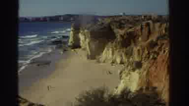 Greece (1976): View Of Nature Sandy Beach And Rocks Surrounding Scene While People