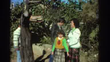 Greece (1976): Family Of Four Walking Through Park Looks At Wood Sign