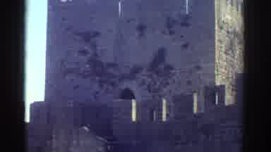 GREECE-1976: A Woman Climbs The Steps Of An Ancient Castle-Like Structure On A