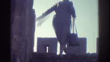 Greece (1976): Woman Wearing A Hat And Carrying Purse Climbs Castle Wall