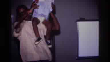 Harlem New York USA (1976): Young Girl Being Held By Older Boy, Three Kids Playing