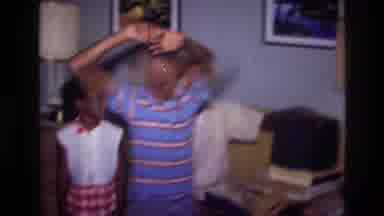 Harlem New York USA (1976): A Boy Dancing Before His Family Members In The House