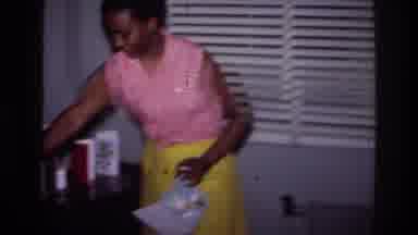 Harlem New York USA (1976): Mother Setting Up Birthday Cards For Her Son While He
