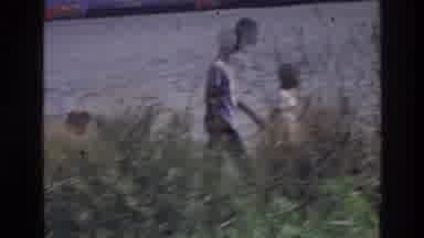 Harlem New York USA (1976): Family Enjoys The Outdoors By Water And Shrubbery On
