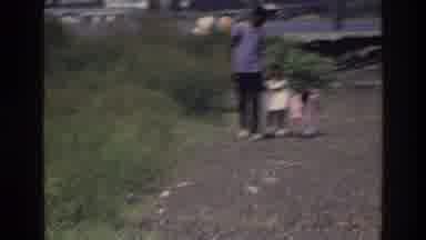 Harlem New York USA (1976): Men And Children Walking Down A Gravel Path In A Field