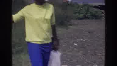 Harlem New York USA (1976): Woman Plays With Child By The Water With Joy In