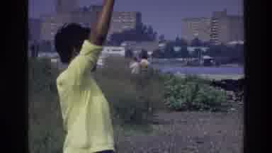 Harlem New York USA (1976): Mom Throws Ball Into An Icy Lake Letting Son Roam Free