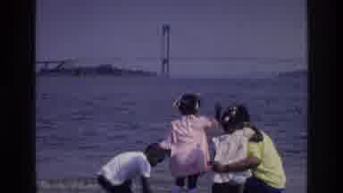 Harlem New York USA (1976): Four Kids Are On A Rocky Beach As Two Of Them Throw