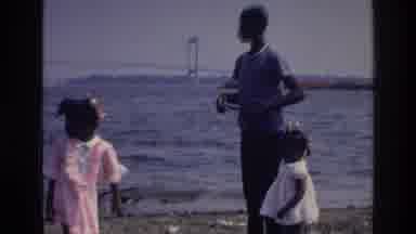 Harlem New York USA (1976): Boy With Two Children By The Bay On A Nice Sunny Day