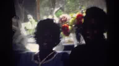 Harlem New York USA (1976): Couple Laughing While They Look At Photograph