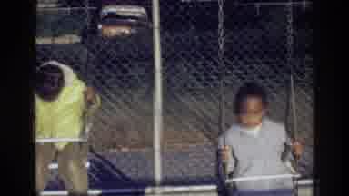 Harlem New York USA (1976): Two African American Kids On The Swings Of A Park And