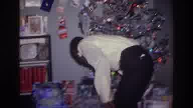 Harlem New York USA (1976): A Man Looking For Gifts Under A Christmas Tree