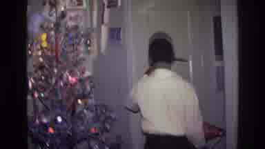 Harlem New York USA (1976): Young Boy Hanging Christmas Decorations By The