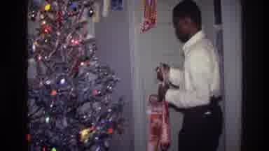 Harlem New York USA (1976): Christmas Tree Being Decorated By Boy Excited About
