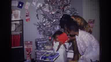 Harlem New York USA (1976): Mother Children Prepare To Open Gifts In Festive