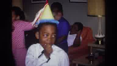 Harlem New York USA (1976): Boy Wearing Party Hat Enjoys Social Event With Other