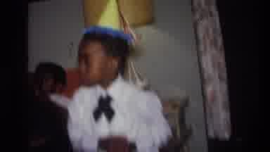 Harlem New York USA (1976): Boy In Party Hat Dancing In A Living Room Full Of