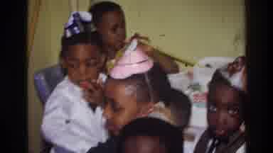 Harlem New York USA (1976): Black Children Wear Party Hats While Seated And