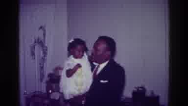 Harlem New York USA (1976): Black Men Dancing With Infant In A Celebration All Of