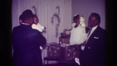 Harlem New York USA-1976: Men Hold Baby and Girl at Family Gathering