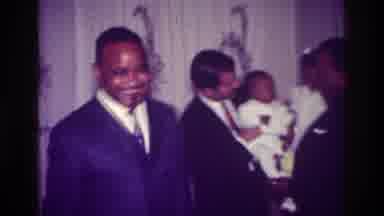 Harlem New York USA (1976): Many Men Playing With Little Baby At Large Birthday
