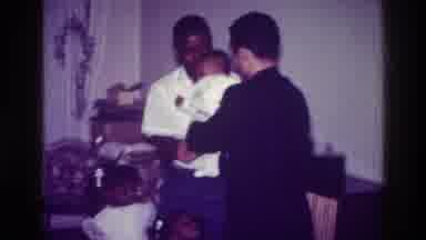 Harlem New York USA (1976): Man Celebrates The Birth Of His Son With Friend In The
