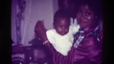 Harlem New York USA (1976): Family Video With A Woman Holding A Baby And Smiling