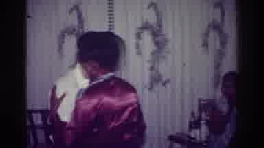 Harlem New York USA (1976): A Couple Dancing Indoors While Someone Else Sits