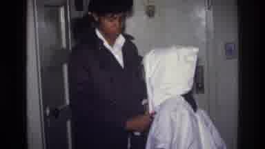 Harlem New York USA (1976): A Girl Shows To The Child A Clown With A Handkerchief