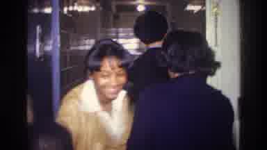 Harlem New York USA-1976: A Group Of People Laughing Having A Good Time As They Walk Through Hallway