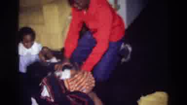 Harlem New York USA (1976): Children Wearing Bright Clothing Playing On Floor Near