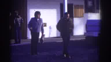Watkins Glen New York USA (1976): Group Of People Outside A Motel In Winter