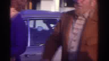 Watkins Glen New York USA (1976): One Man Is Shouting Near Car ,A Lady Is Standing
