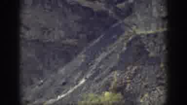 California USA (1937): Man And Woman Walk In Rock Formation On Sunny Day