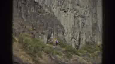 California USA (1937): Woman Carefully Walks Down Steep Rocky Hillside Path In