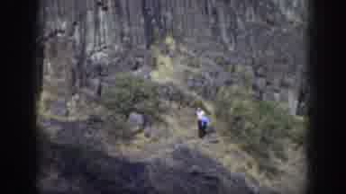 California USA (1937): A Guy Holding A Blue Jacket Walks Down A Trail On A
