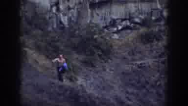 California USA (1937): A Man Trying To Catch Up To A Group Climbing Up A Rock Wall