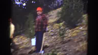 California USA (1938): Men In Orange Hats Standing Outside Watching A Man Pulling