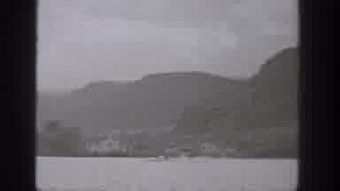 Washington USA (1938): Person In A Boat Speeding Along A Lake On The Side Of A