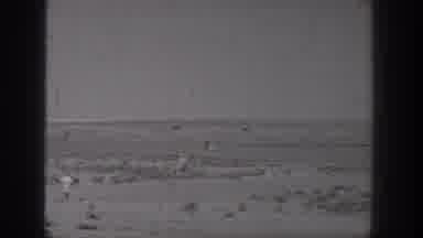 Washington USA (1938): People Watching Model Airplane Fly Over Desert Sands In