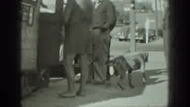 California USA (1939): Bearded Man Takes Dog Out Of A Bus Or Camper While Others
