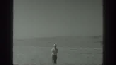 California USA (1939): 4 Men Are Standing In An Open Field Looking Out At Another