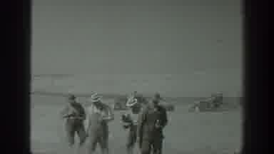 California USA (1939): Farmers Walking Toward Camera With Harvesting Equipment