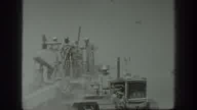 California USA (1939): A Man Drives A Tractor As Other People Stand On The Cutting