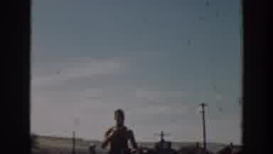 California USA (1939): Man Riding A Horse In A Field With Houses