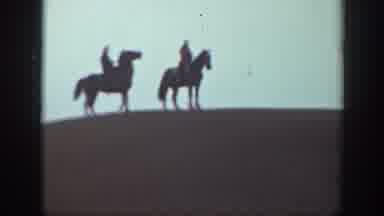 Montana USA (1939): Two Riders On Top Of Horses On Top Of A Hill Walking From Left