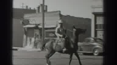 Wyoming USA (1939): Three Men Riding Horses On Main Street Of A Town, Black And