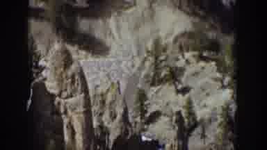 Wyoming USA (1939): A Waterfall Spills Down A Cliff Populated With Small Conifer